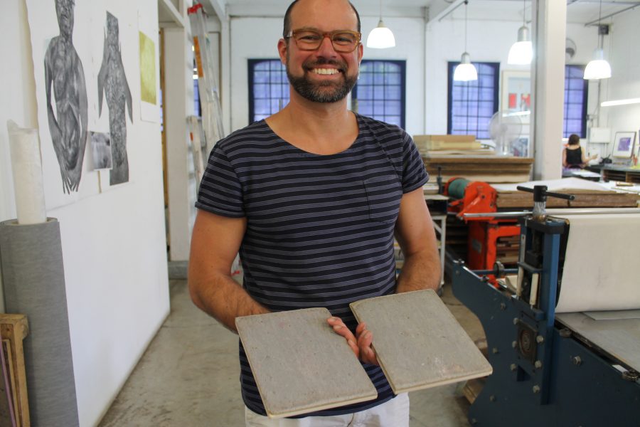 Alonzo-Barkigia holdingup his lino plates. He explains: “I attached these plates to the bottom of my shoes and walked 5km across Johannesburg. I’m very curious to see the results.” So are we – stay tuned and all will be revealed on his return to AOM in a couple weeks.