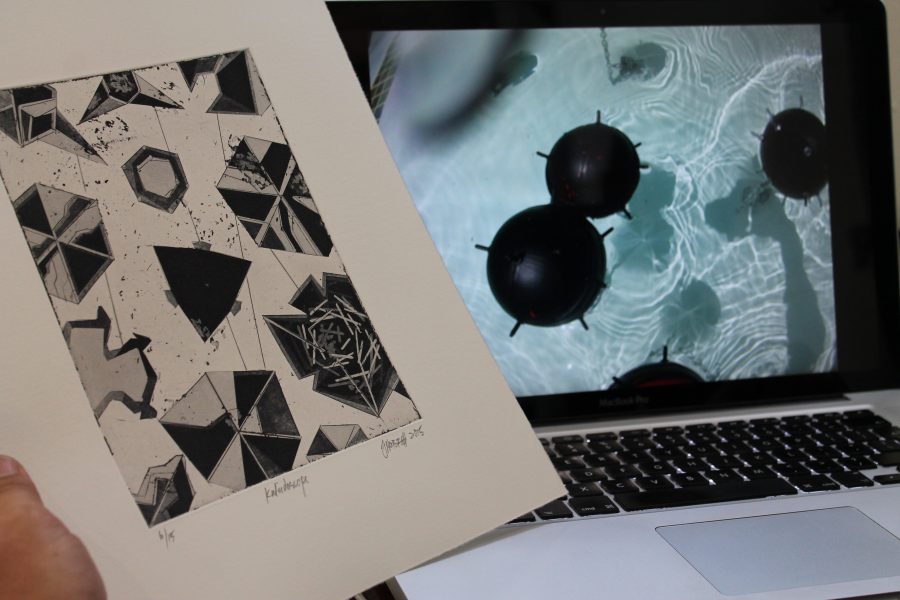 Hobbs holds Kaleidoscope up against a still from his contact mine set to contextualize his ideas for the etching. 